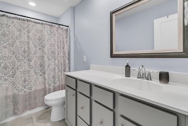 bathroom featuring tile patterned flooring, toilet, and vanity