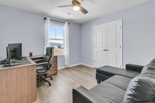 office featuring visible vents, baseboards, light wood-style floors, and a ceiling fan