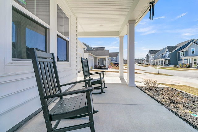 view of patio with a residential view and a porch