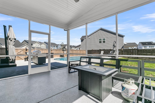 sunroom / solarium with vaulted ceiling and a residential view