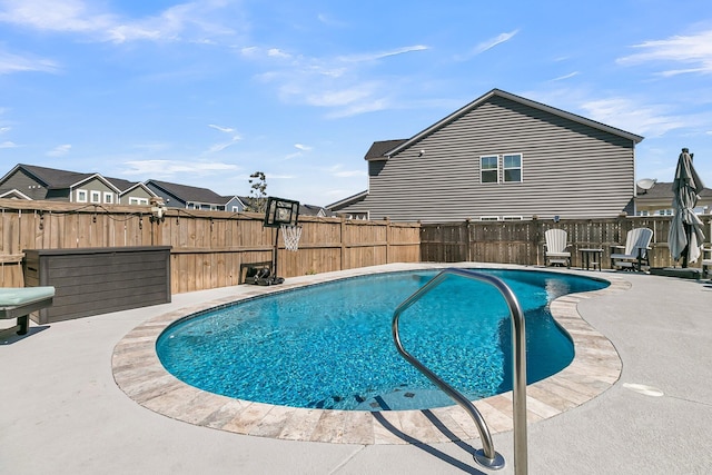 view of swimming pool featuring a patio area, a fenced in pool, and a fenced backyard