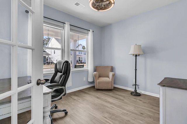 office with wood finished floors, visible vents, and baseboards