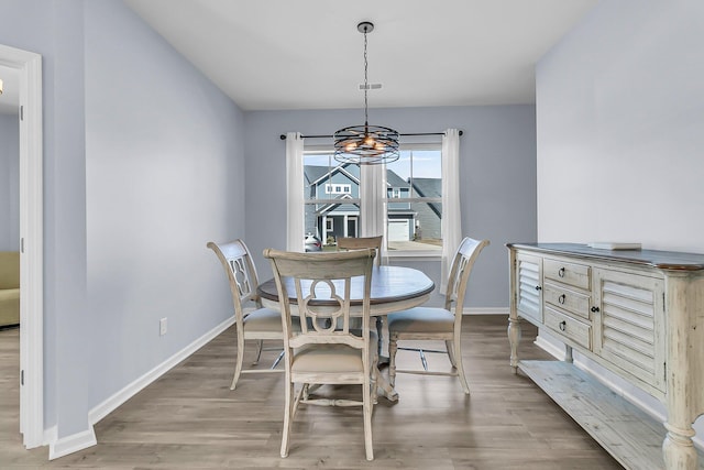 dining room featuring baseboards and wood finished floors