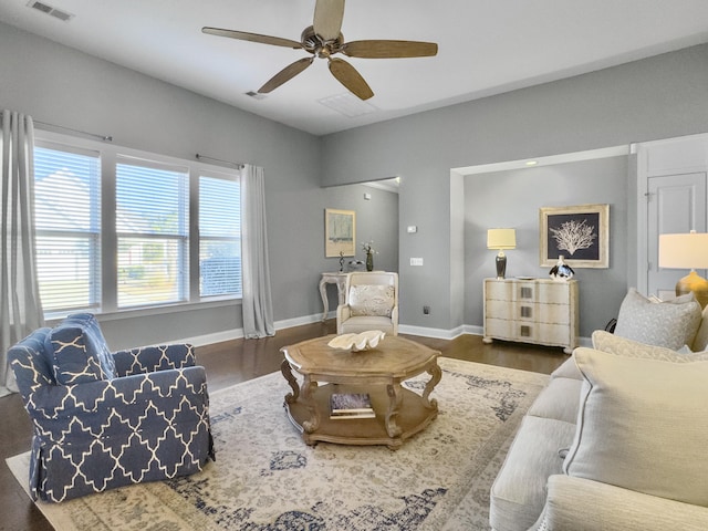 living room with dark wood-type flooring and ceiling fan