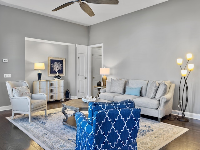 living room with ceiling fan and dark hardwood / wood-style flooring