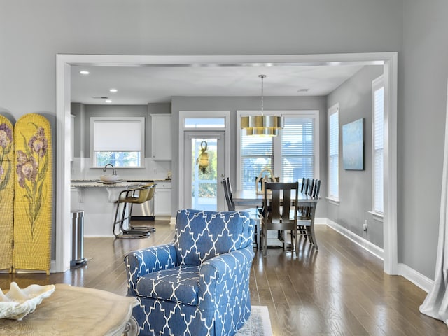 dining room with dark hardwood / wood-style flooring and sink