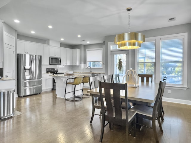 dining area with hardwood / wood-style flooring and sink