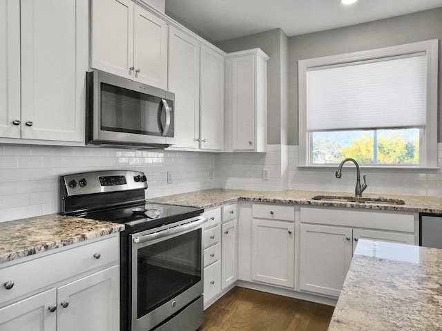 kitchen with white cabinetry, sink, stainless steel appliances, and dark hardwood / wood-style floors