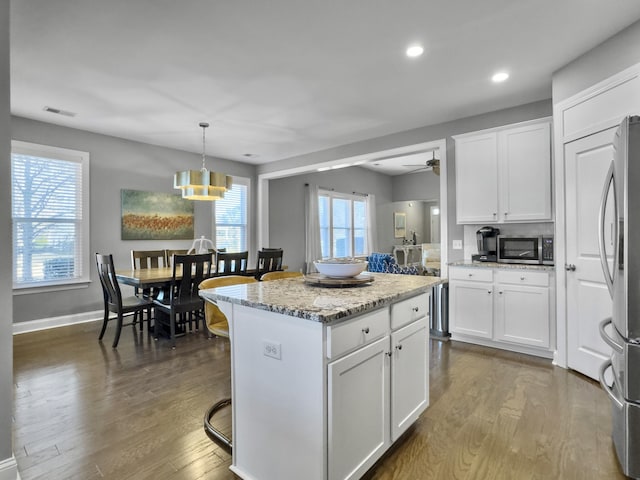 kitchen featuring white cabinetry, a kitchen island, and appliances with stainless steel finishes