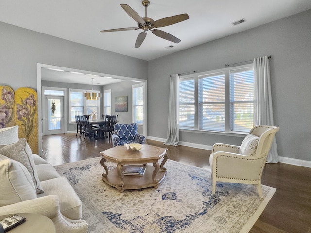 living room featuring dark hardwood / wood-style floors and ceiling fan