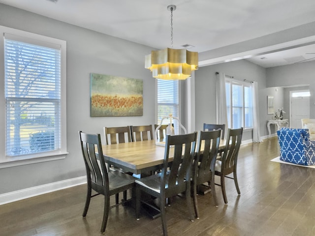 dining room featuring dark hardwood / wood-style flooring and a notable chandelier