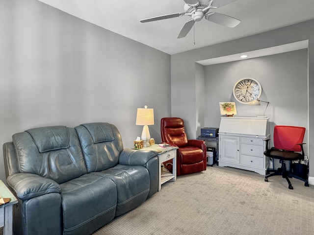 carpeted living room featuring ceiling fan