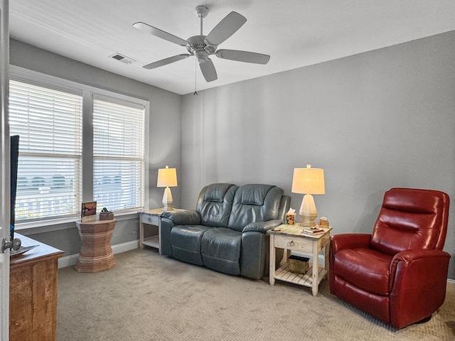 living room with light carpet and ceiling fan