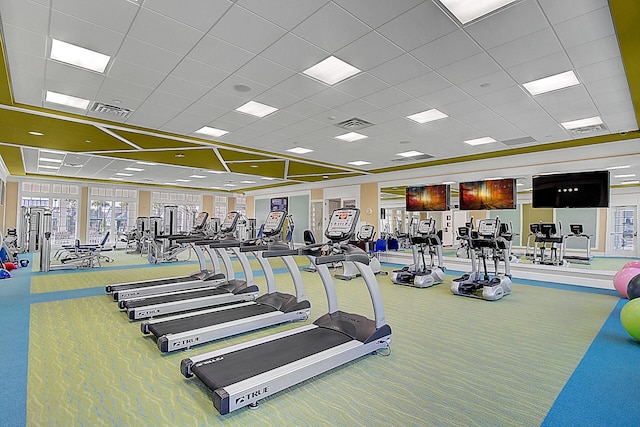 gym featuring carpet floors and a drop ceiling