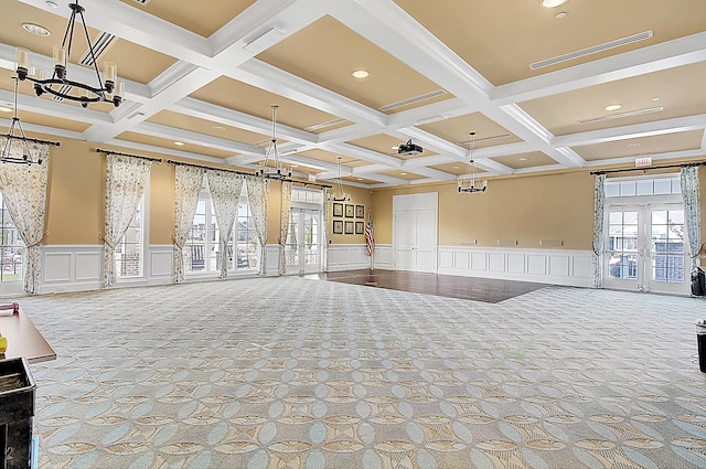 interior space with french doors, light colored carpet, and beam ceiling