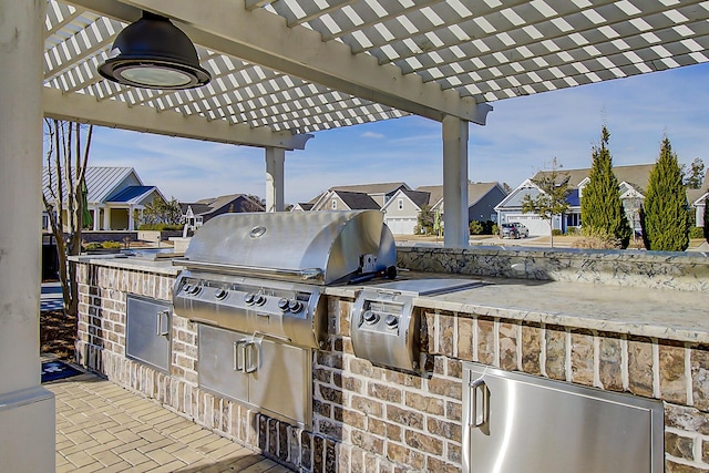 view of patio / terrace with area for grilling, a grill, and a pergola