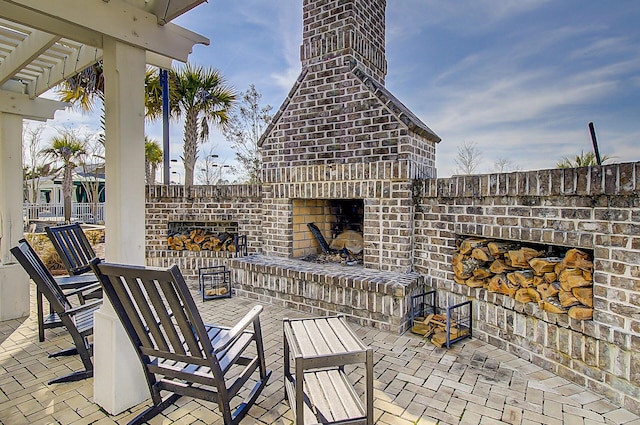 view of patio / terrace featuring an outdoor brick fireplace