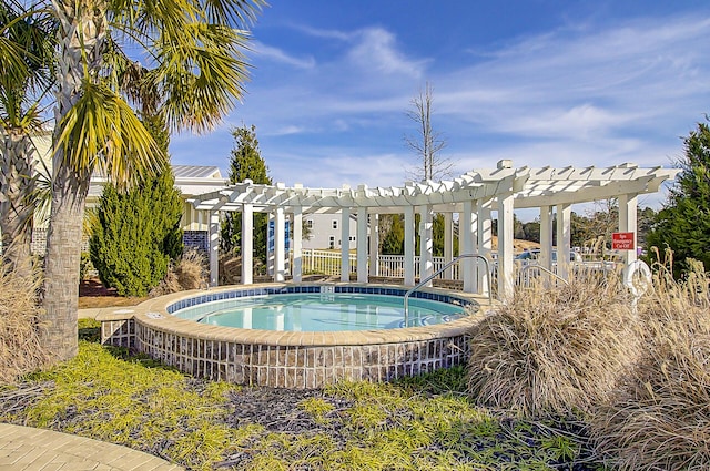 view of swimming pool featuring a pergola and a hot tub