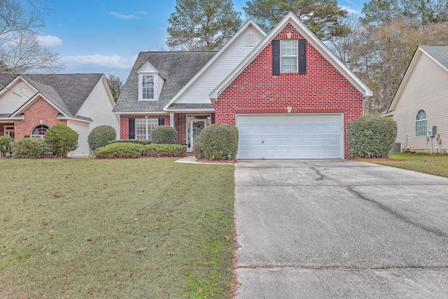 view of front of property with a garage, a front yard, and central air condition unit