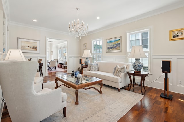 living room featuring a chandelier, crown molding, and hardwood / wood-style flooring