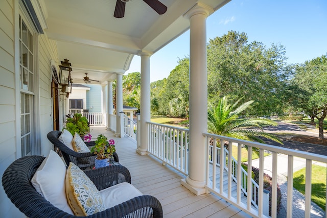 wooden terrace with covered porch and ceiling fan