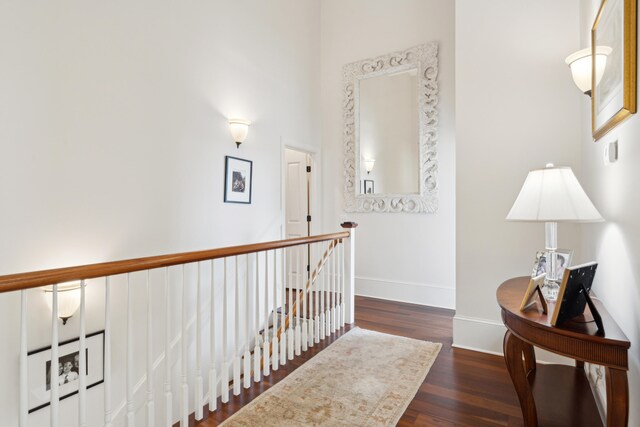 hallway with dark hardwood / wood-style floors