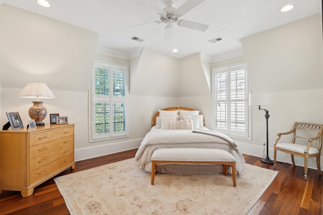 bedroom with dark hardwood / wood-style floors, ornamental molding, multiple windows, and ceiling fan