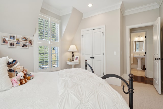 bedroom featuring light colored carpet, a closet, crown molding, and sink