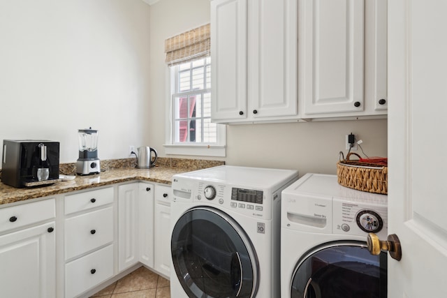 laundry room with independent washer and dryer, light tile patterned flooring, and cabinets