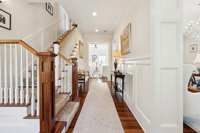 interior space with a notable chandelier, crown molding, and dark hardwood / wood-style floors