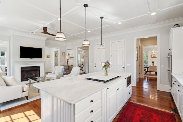 kitchen featuring white cabinets, plenty of natural light, dark wood-type flooring, and a kitchen island