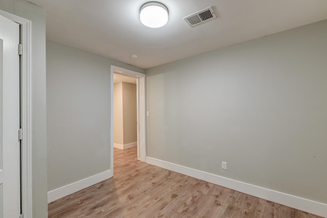 empty room with light hardwood / wood-style flooring