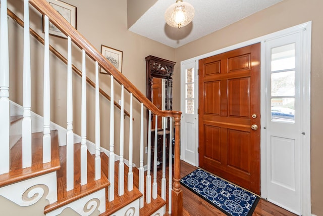 entryway featuring wood finished floors and stairs