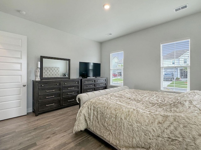 bedroom with visible vents and wood finished floors