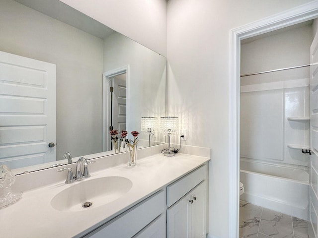 bathroom featuring marble finish floor, shower / bathing tub combination, vanity, and toilet