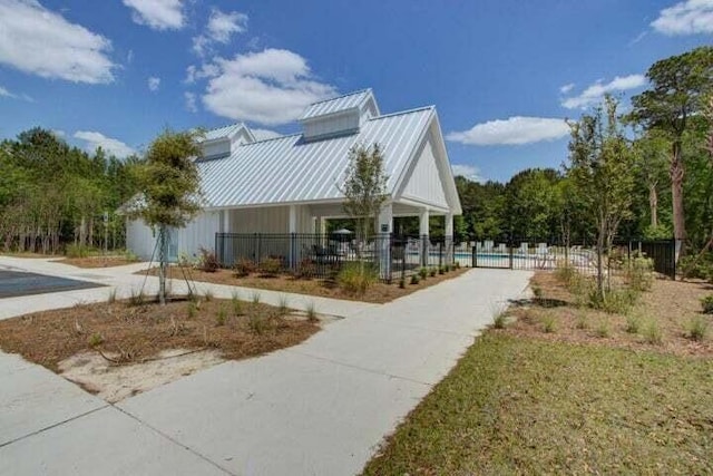 surrounding community featuring driveway, a swimming pool, and fence