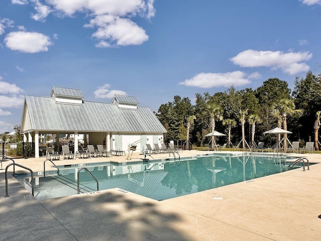 pool featuring a patio area and fence