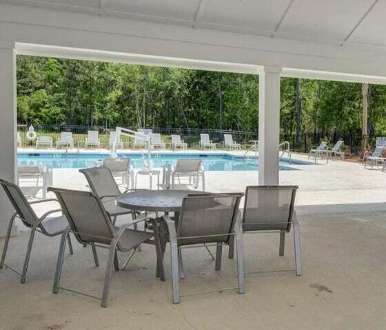 community pool featuring a patio and fence