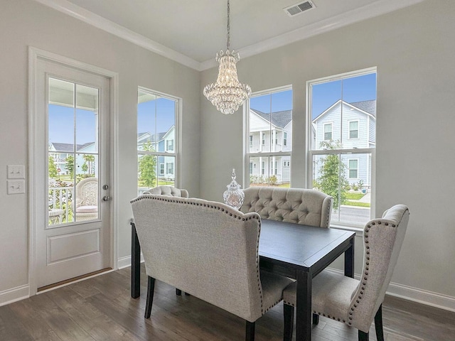 dining area with baseboards, visible vents, dark wood finished floors, an inviting chandelier, and crown molding