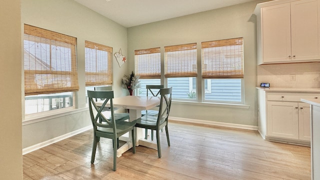 dining space with light hardwood / wood-style flooring