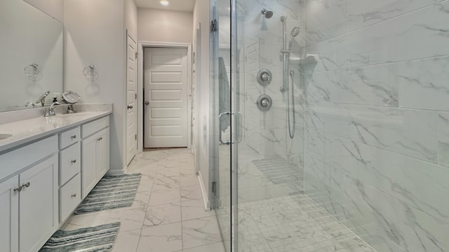 bathroom with vanity and a shower with door