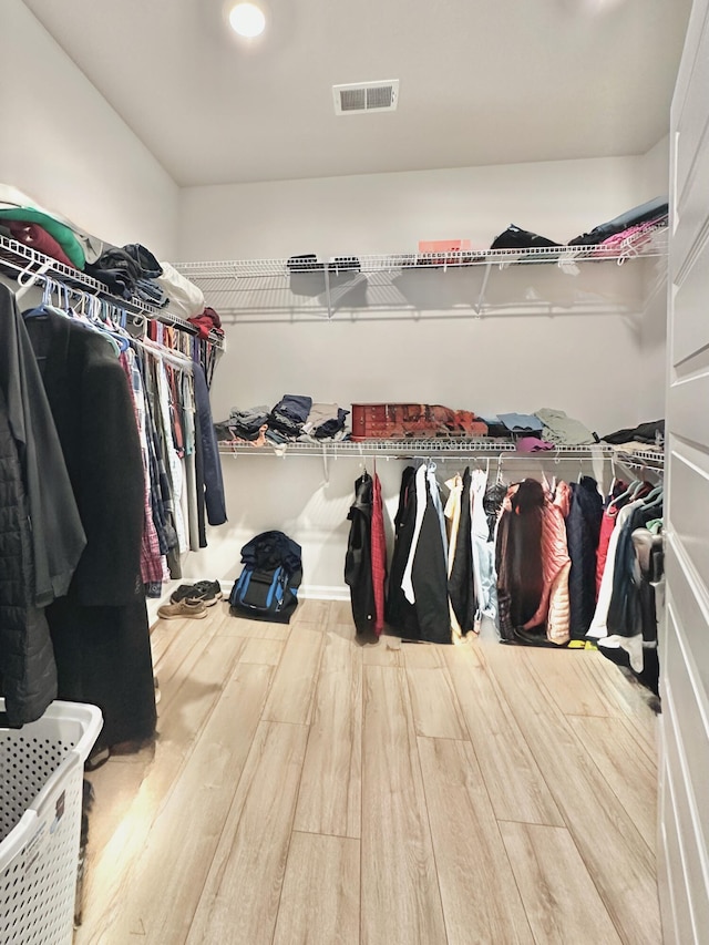 spacious closet featuring hardwood / wood-style floors