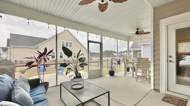 sunroom / solarium featuring ceiling fan