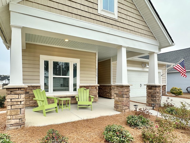 view of patio with a porch and a garage