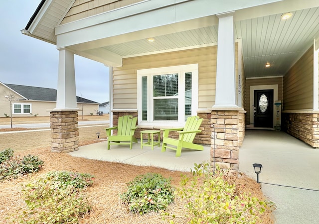 view of exterior entry featuring covered porch