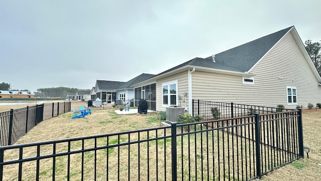 view of home's exterior with a yard and central AC unit