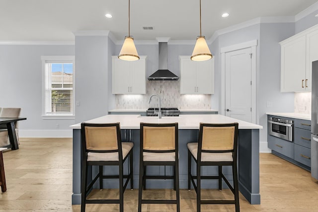 1182 Welcome Dr, Mount Pleasant, SC 29464 - kitchen featuring wall chimney range hood, light countertops, ornamental molding, decorative backsplash, and recessed lighting