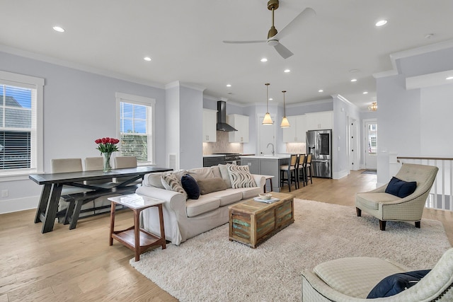 1182 Welcome Dr, Mount Pleasant, SC 29464 - living room featuring crown molding, a ceiling fan, light wood-style flooring, recessed lighting, and baseboards