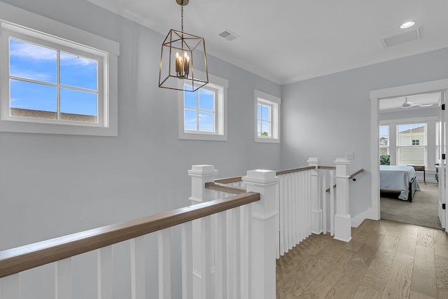 1182 Welcome Dr, Mount Pleasant, SC 29464 - corridor featuring an upstairs landing, light wood-style floors, a chandelier, and baseboards