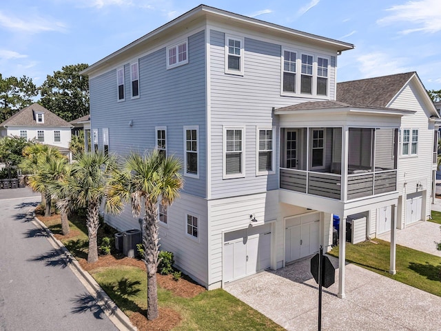 1182 Welcome Dr, Mount Pleasant, SC 29464 - view of front of property with a garage, driveway, a shingled roof, and central air condition unit